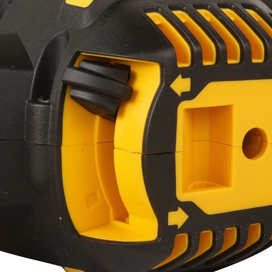 Close-up of a DEWALT tool body showing yellow and black plastic details with vent and arrow markings.
