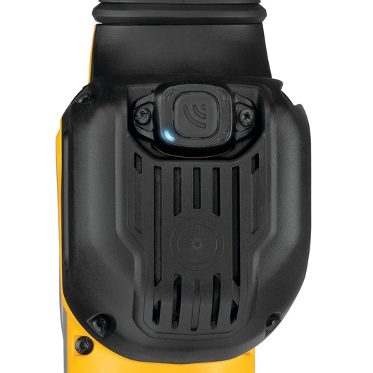 Close-up image of a DEWALT tool showing the top section with a black protective cover and a control button featuring a wireless or connectivity icon with a small blue indicator light.