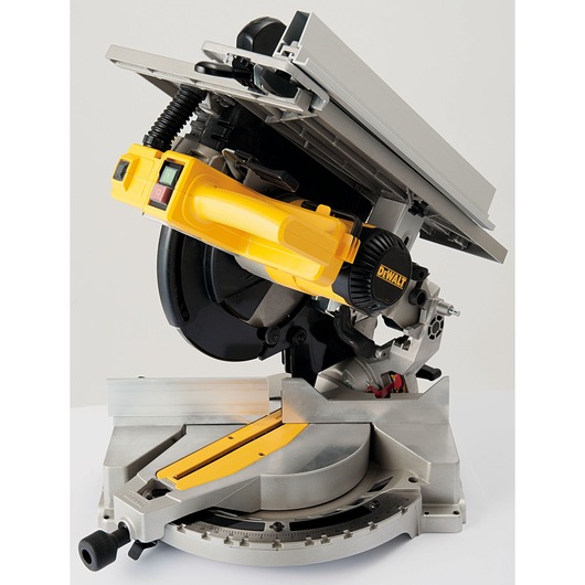 A close-up view of a DEWALT branded compound miter saw, featuring a yellow and black handle and a metallic base, designed for precision wood cutting.