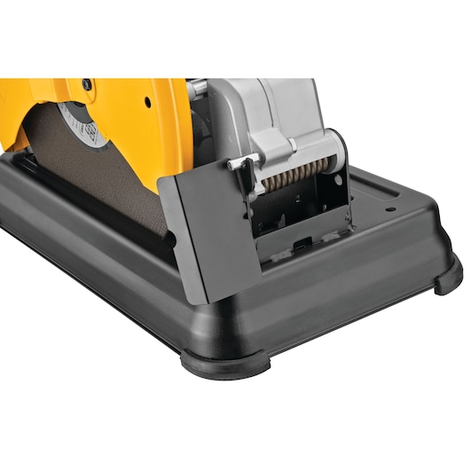 Close-up view of a DEWALT metal cutting power tool, showing the base and part of the abrasive cutting disc, with a protective guard and sturdy construction.