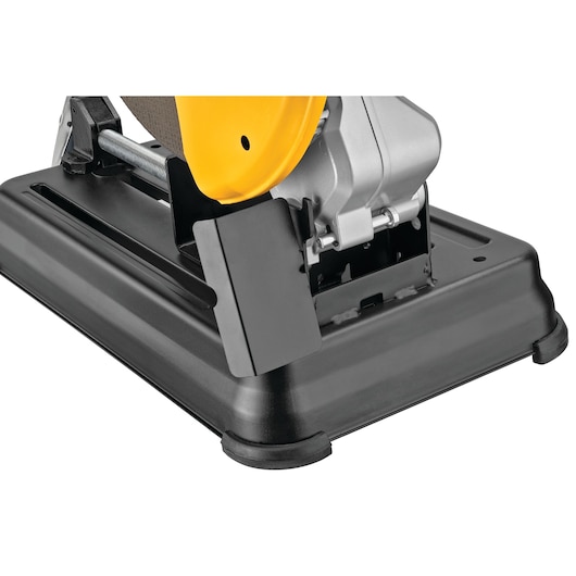 Close-up view of the base and lower parts of a DEWALT power tool, showing its sturdy black platform and partial yellow and silver motor housing.