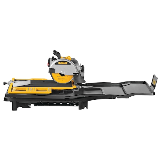 DEWALT D36000 tile saw with a yellow and black body, mounted on a table with an extended side tray for holding materials.