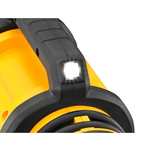 Close-up of a DEWALT portable air compressor showing its integrated LED work light turned on, with a prominent yellow and black design.