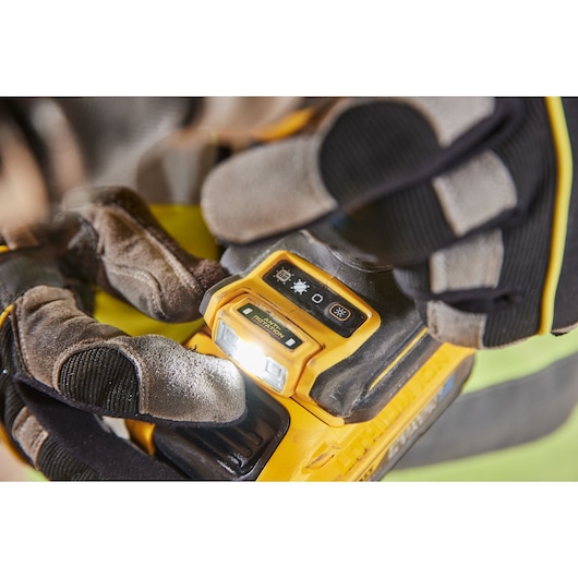 DEWALT tool close-up, gloved hand adjusts light. SKUs: DCD1007NT, DCZ607X2-XE.