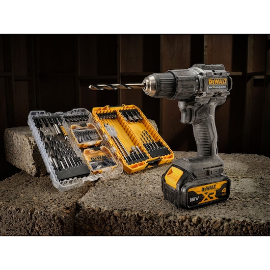DEWALT cordless drill and drill bit sets displayed on concrete blocks in a workshop setting.