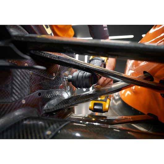 DEWALT DCD803D2T-QW, DCD803D2T in use on a car part. Photography product category. Close-up view.
