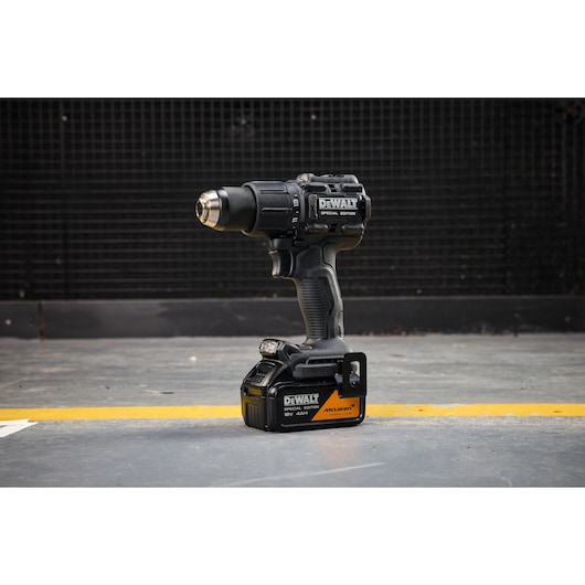 DEWALT cordless drill, black special edition, shown upright on a workshop floor, with visible branding.
