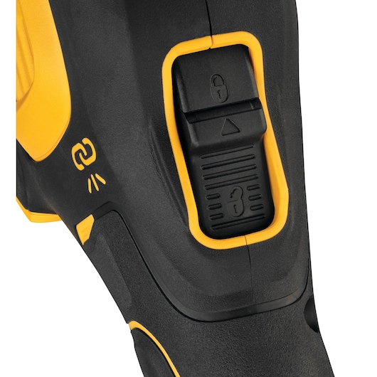 Close-up of a DEWALT tool's lock switch and yellow-black handle grip.