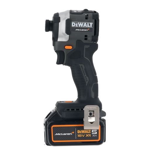 A DEWALT McLaren-branded cordless impact driver with a black and silver body, featuring an 18V XR 5Ah battery, orange accents, and a metal belt clip. The tool is labeled 'Brushless' and prominently displays the DEWALT and McLaren logos.