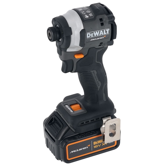 A DEWALT McLaren branded cordless impact driver with a black and orange design, featuring an 18V XR lithium-ion battery and a metal belt clip.