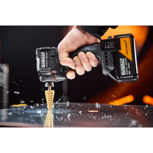 DEWALT x McLaren F1 Team 18V XR Special Edition Impact Driver  with 4Ah battery drilling metal sheeting with a step drill bit
