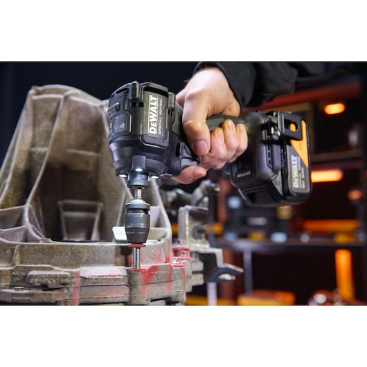 DEWALT DCF86MP2T-QW, DCF86MP2T impact driver in use; product from Photography category, close-up hand operation.