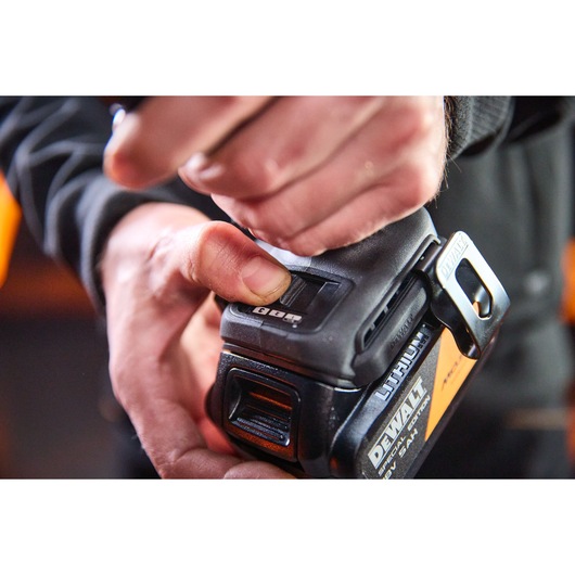 DEWALT DCF86MP2T-QW and DCF86MP2T lithium unit in hand, showing battery and tool close-up.