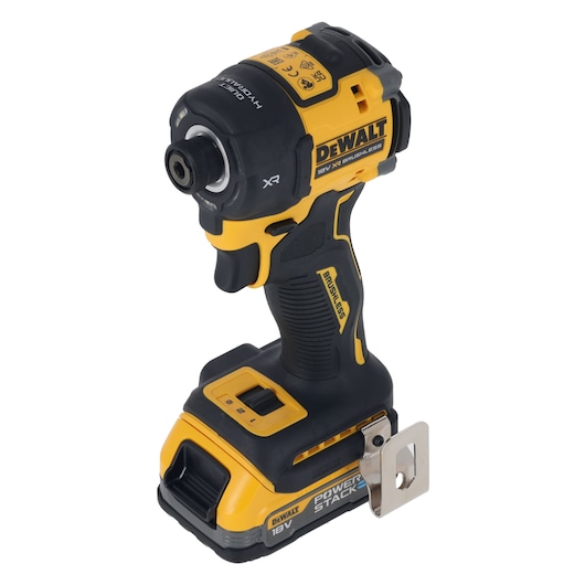 A DEWALT 18V XR brushless cordless impact driver with Powerstack battery, shown standing upright with a metal belt clip attached.