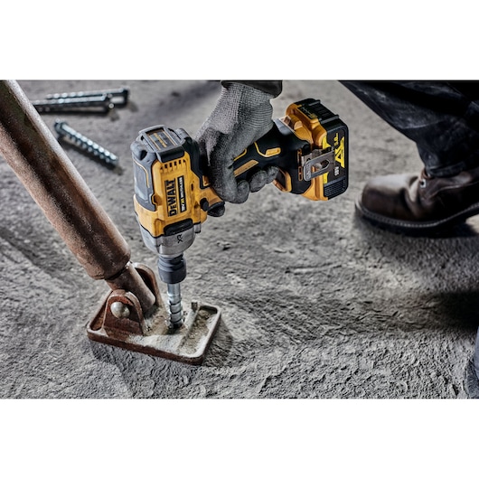 DEWALT drill used on metal, SKUs DCF892N and DCZ407P1T1-XE shown. Construction setting, close-up photo.