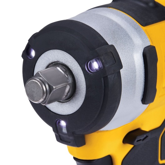 Close-up view of the front end of a DEWALT cordless impact wrench, showing the metallic hex drive and surrounding LED lights, with a yellow and black casing.