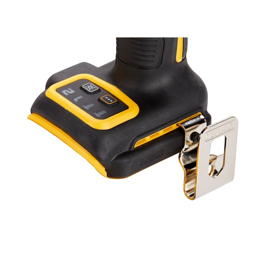 Close-up view of the base of a DEWALT power tool, showing the control buttons, yellow and black design, and a metal belt clip attached.