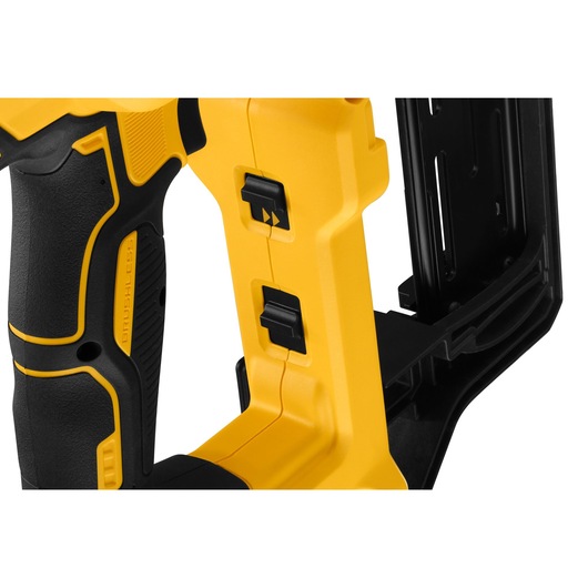 Close-up of a DEWALT tool handle with black and yellow switches and textured grip.
