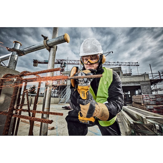 DEWALT DCG406N, DCZ409P2-XE, DCZ401P3-XE, DCG406 tools used for cutting metal at a construction site.