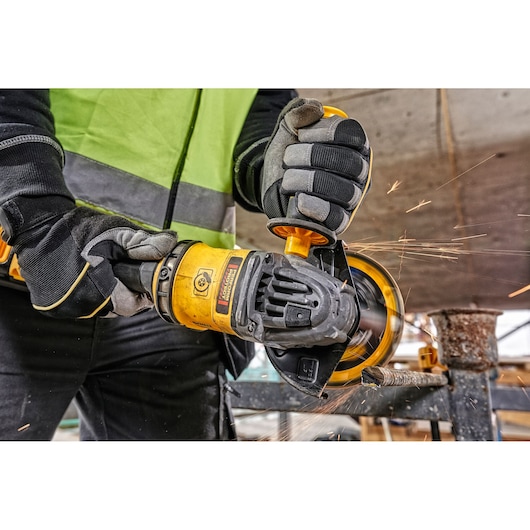 DEWALT tools in use with sparks. Shown: DCZ507T2-XE, DCG418N, DCZ503X2-XE. Photography category, ASIA EMEAANZ.