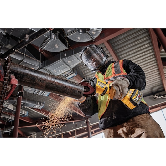 DEWALT tools DCZ507T2-XE, DCG418N, DCZ503X2-XE used for metal grinding on site. Photography category.