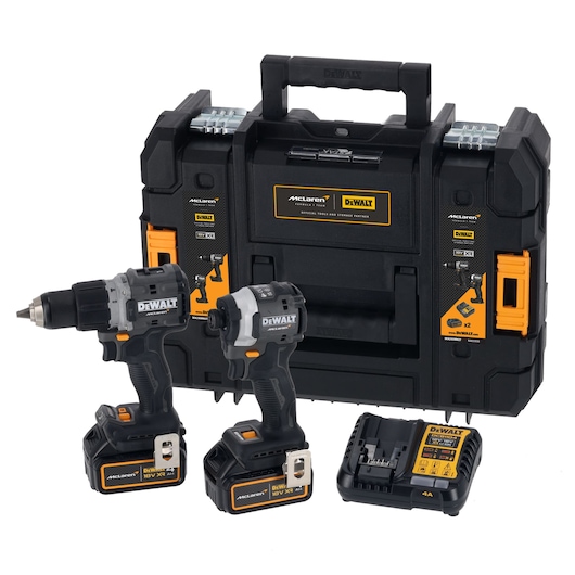 A DEWALT tool set featuring two cordless power tools, a drill and an impact driver, each with a battery attached. The set includes a battery charger and a sturdy black carrying case with orange and silver accents, displaying DEWALT and McLaren branding.