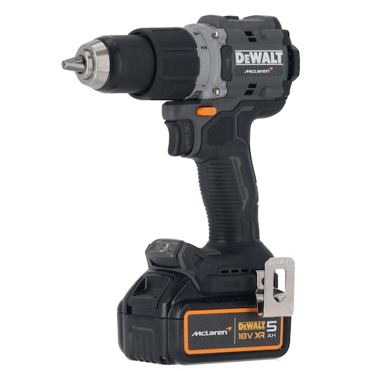A DEWALT McLaren branded cordless power drill with an 18V XR lithium-ion battery. The drill is black and grey with orange accents and features a brushless motor, ergonomic handle, and a metal belt clip.