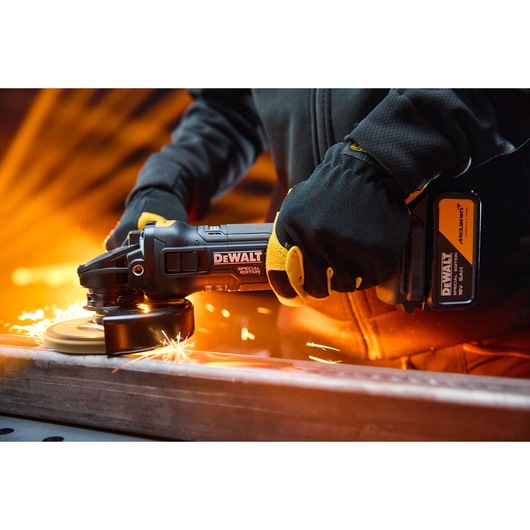 DEWALT grinder in use, sparks flying. SKUs: DCK2223MP2T-QW, DCK2223MP2T. Photography product category.