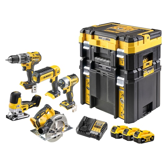 DEWALT power tool kit including five cordless tools (drill, impact driver, jigsaw, circular saw, and flashlight), three 18V batteries, a battery charger, and a set of black and yellow stackable storage cases.