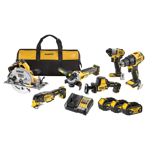 DEWALT tool kit including a black and yellow carry bag, a circular saw, angle grinder, oscillating tool, impact driver, drill, reciprocating saw, multi-voltage charger, and three 18V batteries, all arranged on a white background.