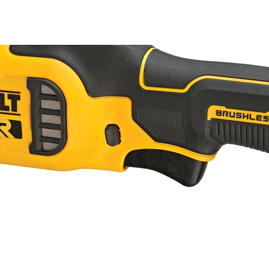 Close-up view of the handle section of a DEWALT brushless power tool, showing a yellow and black design, a lock symbol, and part of the trigger.