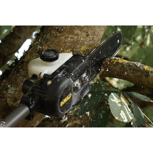 DEWALT saw cutting tree branch. SKUs: DCMASED57X1, DCMASED9N, DCMASPH6N, DCMASPS5N, DCMASST1N, DCMASBC1N, DCMAS5713X1