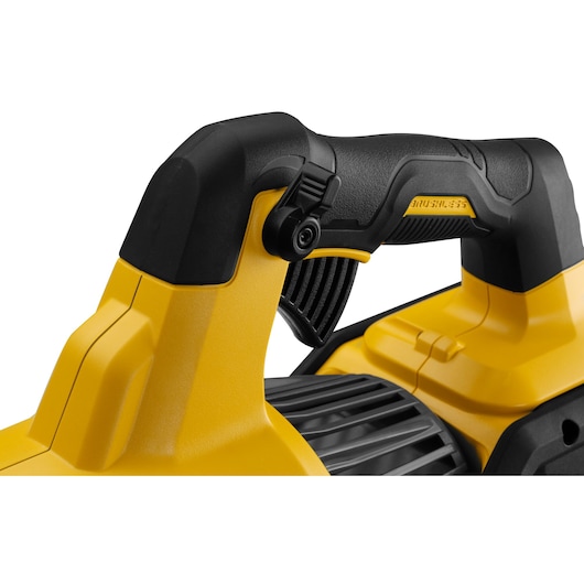 Close-up of a yellow and black DEWALT power tool handle with trigger and grip detail.