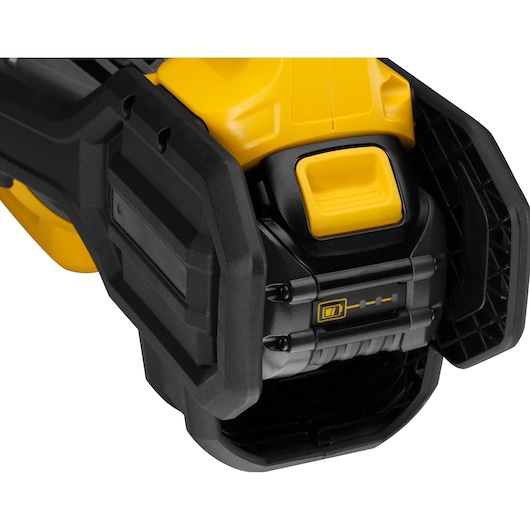 Close-up of DEWALT DCMBA572N cordless tool showing battery compartment and indicator lights.