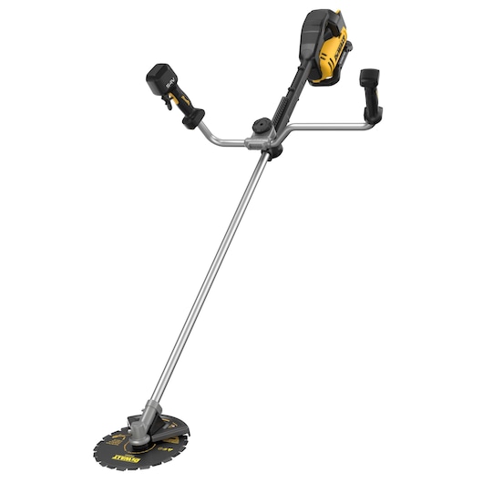 A DEWALT cordless brush cutter with a dual handlebar, metal cutting blade, and battery pack attached. The tool is designed for trimming tough vegetation and features a yellow and black color scheme.
