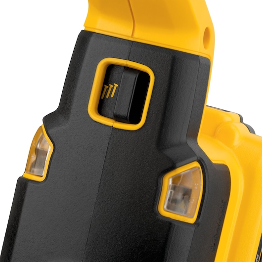 Close-up of a yellow and black DEWALT tool with switch and transparent indicator lights.