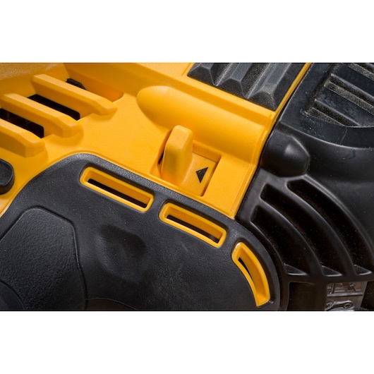 Close-up of DEWALT DCN693N power tool body showing yellow and black casing with detail of adjustment lever.
