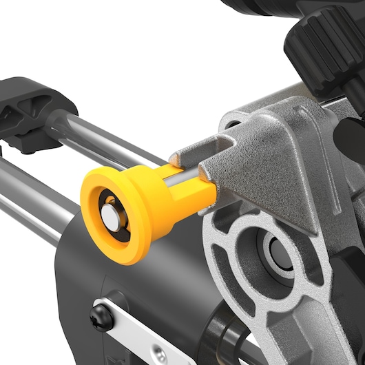 Close-up view of a DEWALT power tool component, showing a yellow knob attached to a metal frame, used for adjusting or securing parts.