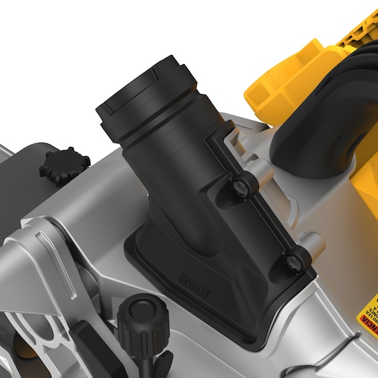 Close-up image of a DEWALT power tool component, showing a black plastic dust extraction port attached to a metallic and yellow machine body. The image highlights several knobs and mechanical parts in detail.