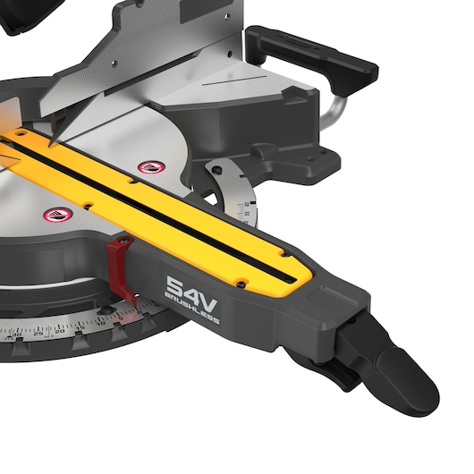 Close-up view of a DEWALT 54V brushless mitre saw, showing the cutting blade, handle, and measurement markings on the base.