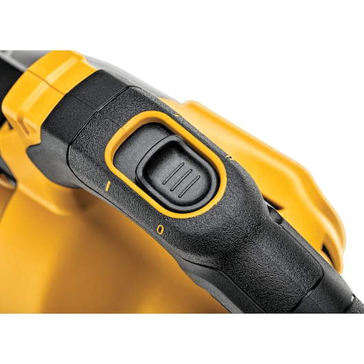 Close-up view of the DEWALT DCV501LN power tool, focusing on its black and yellow switch handle with an ergonomic grip and marked positions.