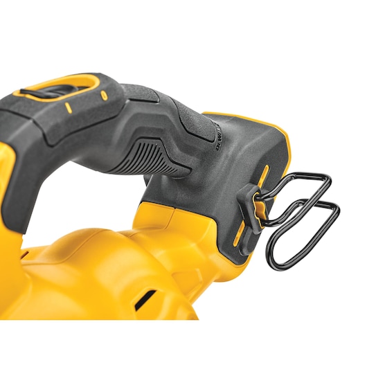 Close-up view of the handle and belt hook of a DEWALT power tool, showing the textured grip in black and yellow and the attached metal hook.