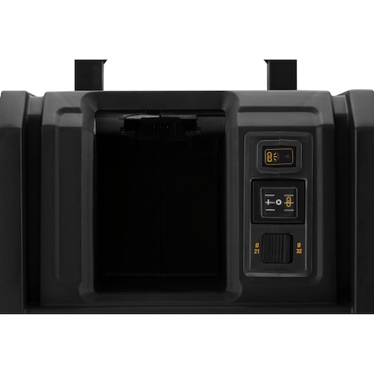 Close-up view of the control panel and compartment of a DEWALT DCV586MN tool. The image shows a rectangular open compartment on the left, and on the right side, three control buttons with yellow and white symbols for adjusting settings.