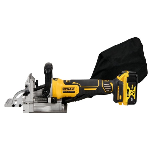 A DEWALT cordless biscuit joiner tool with a yellow and black body, metal adjustment components, and a dust collection bag attached. The tool is powered by an 18V XR lithium-ion battery.