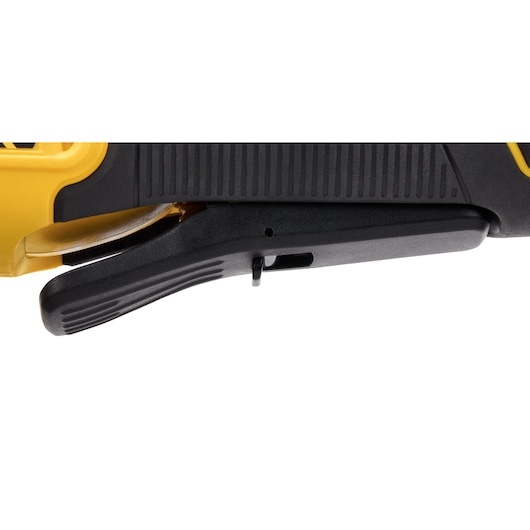 Close-up view of the trigger handle of a yellow and black DEWALT power tool.