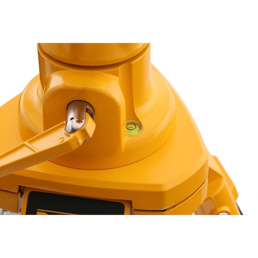 Close-up view of a yellow DEWALT photography equipment component featuring a bubble level and metallic lever.