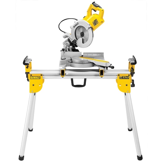 A DEWALT miter saw mounted on a sturdy, foldable stand with yellow and silver metal components, photographed against a white background.