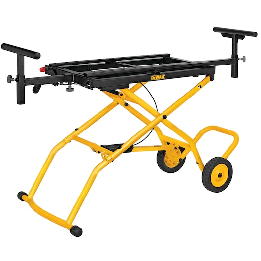 A DEWALT branded yellow and black portable miter saw stand with foldable legs and two wheels for easy transport. The stand features adjustable support arms on both sides.