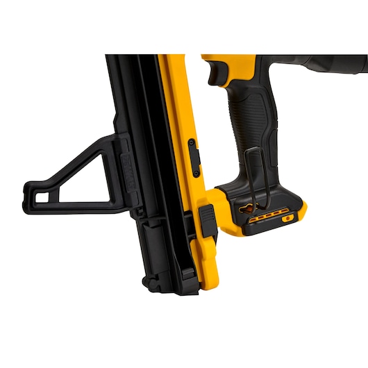 Close-up view of a DEWALT cordless nail gun, featuring a yellow and black design, ergonomic grip, and magazine area.