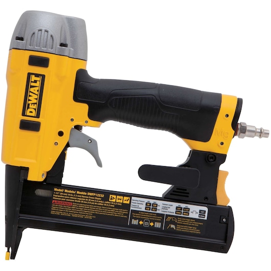 A DEWALT pneumatic nail gun with a yellow and black body, metal top, ergonomic handle, and visible connector for air supply. The tool is shown from the side, displaying its brand logo and warning labels.
